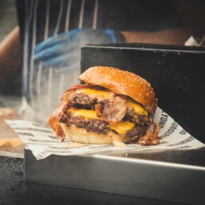 Delicious double cheeseburger with bacon and melting cheese, perfect for fast food lovers.