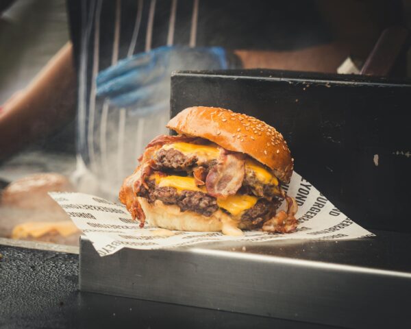 Delicious double cheeseburger with bacon and melting cheese, perfect for fast food lovers.