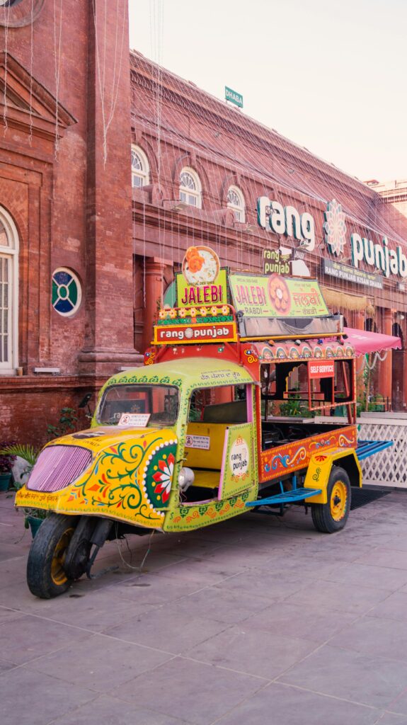 Vibrantly painted three-wheeler vehicle outside a building in Amritsar, India. Traditional Punjabi style.